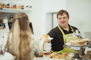 A Person With Down Syndrome Serving in a Cafe