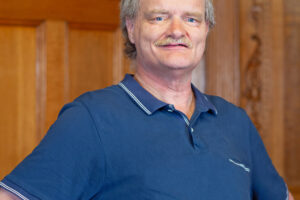 Portrait,Of,Man,With,Down,Syndrome,On,Gray,Background