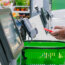 Black guy uses smartphone to pay at self-checkout point